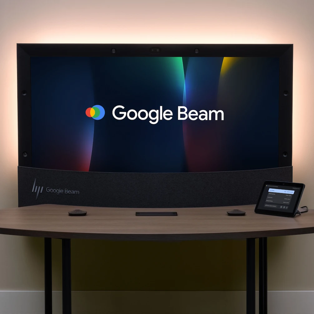 A Google Beam display sits on a desk with the Google Beam logo on the screen.